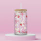 A sweet and soft glass cup covered in bunnies holding strawberries, red bows, white daisies, and hearts. Bunnycore perfection.