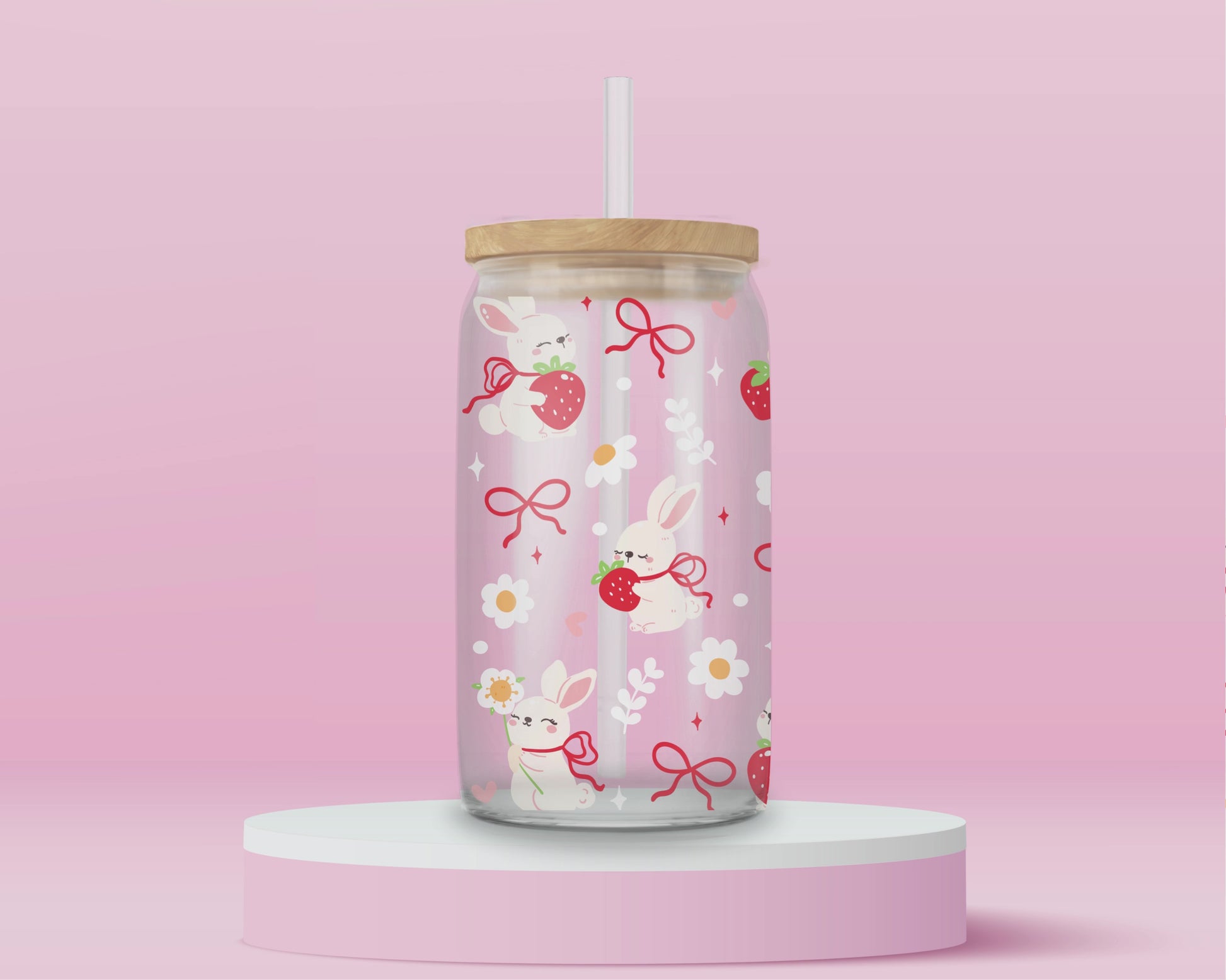 A sweet and soft glass cup covered in bunnies holding strawberries, red bows, white daisies, and hearts. Bunnycore perfection.