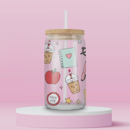 “Teacher-themed glass tumbler with apples, pencils, and stars – cute gift idea for educators.”