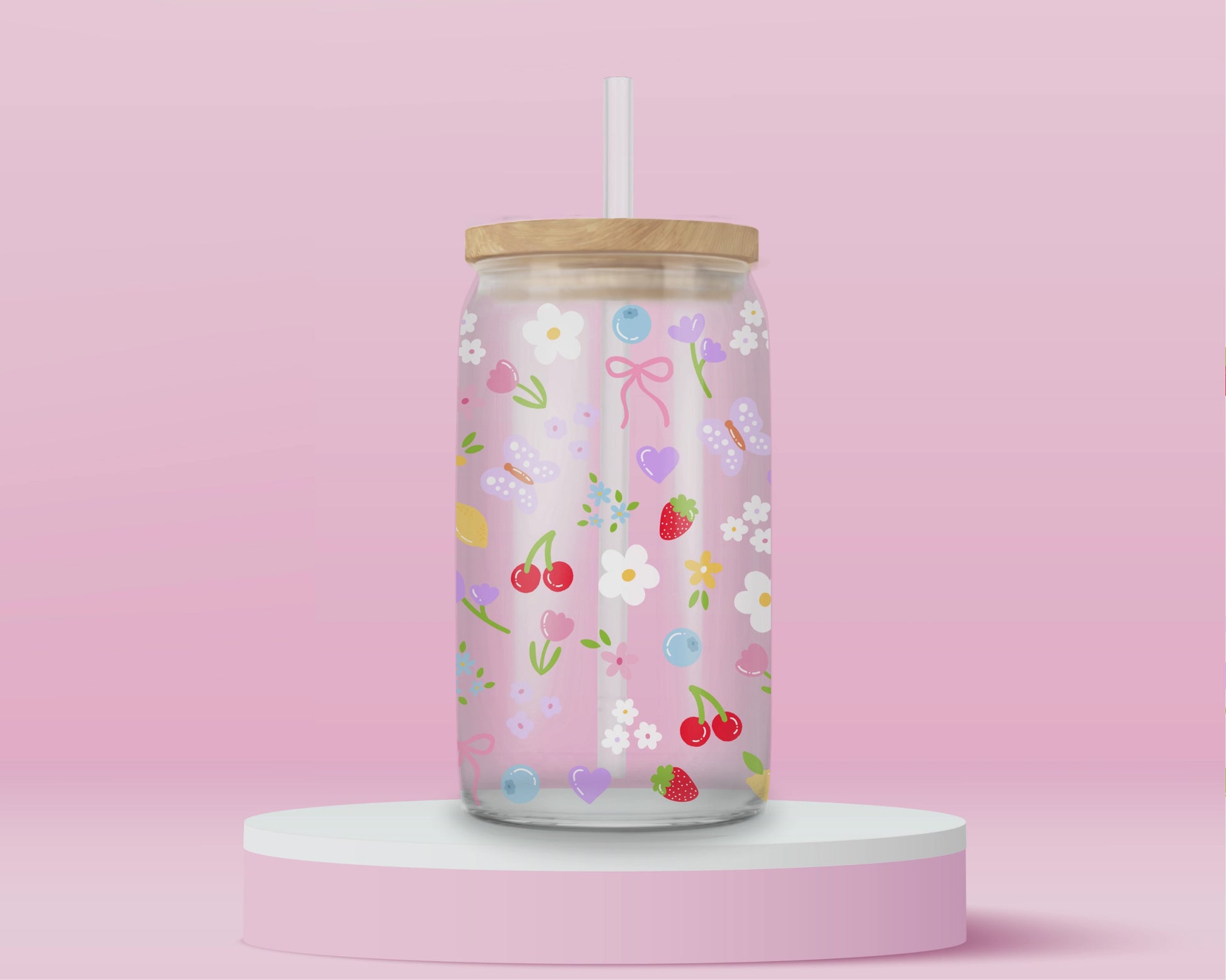 Clear glass can tumbler with a soft pink background, covered in cherries, strawberries, lemons, flowers, bows, and pastel doodles for a sweet garden-inspired look.