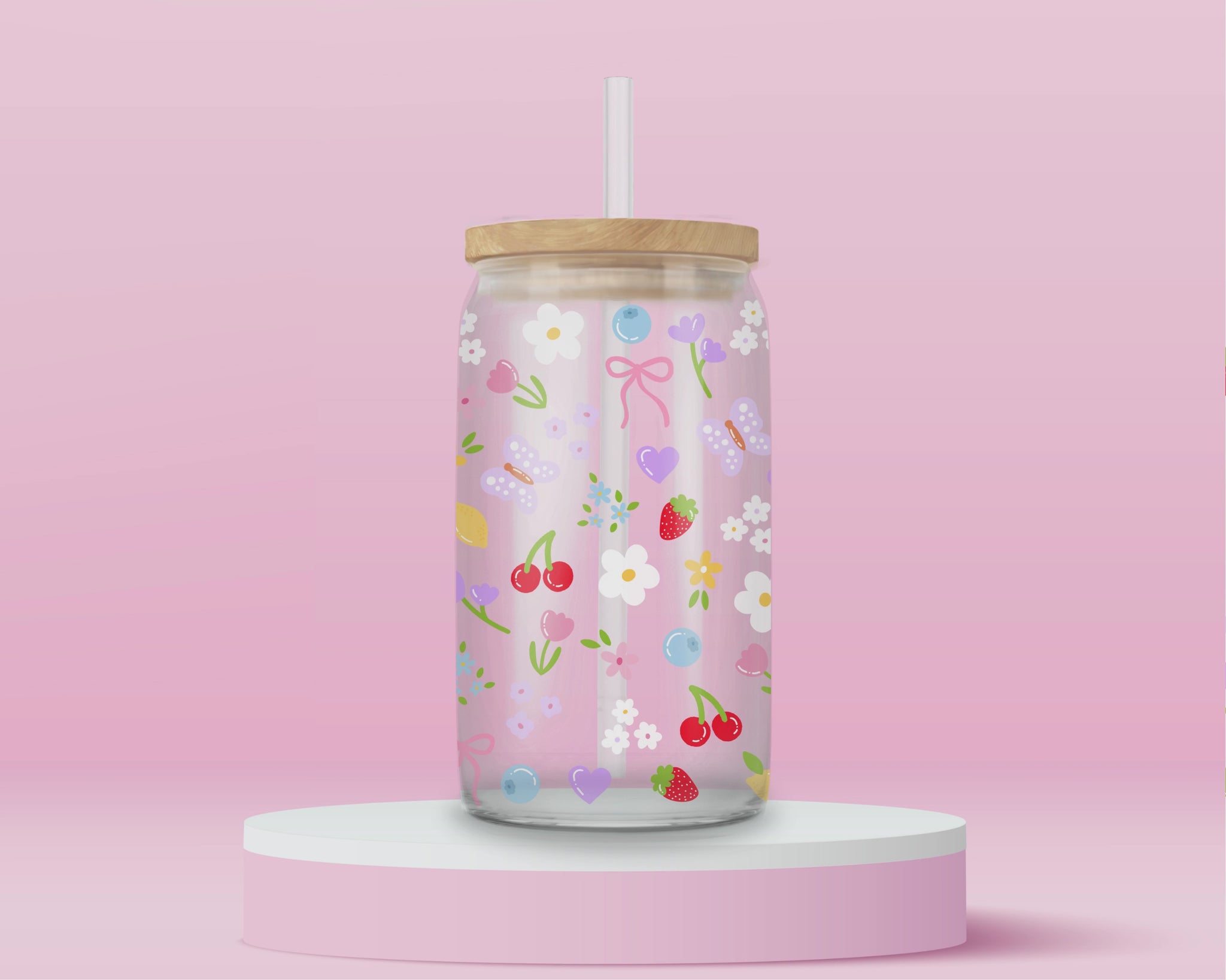 Clear glass can tumbler with a soft pink background, covered in cherries, strawberries, lemons, flowers, bows, and pastel doodles for a sweet garden-inspired look.