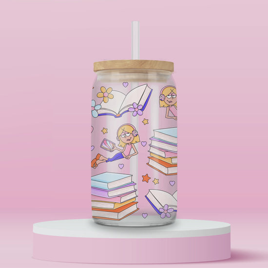 Pink glass tumbler with cartoon Lizzie McGuire reading, surrounded by stacks of pastel books, open pages, hearts, flowers, and stars — perfect for your inner Y2K bookworm.