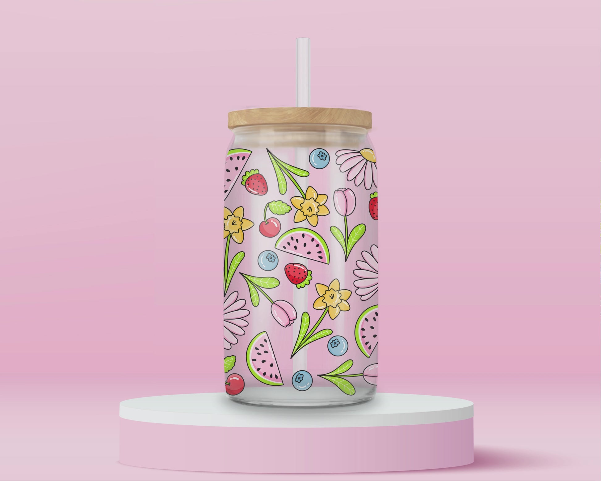 Glass cup with pink background covered in colorful fruits (watermelon, strawberries, blueberries, cherries) and spring flowers (daisies, tulips, daffodils).