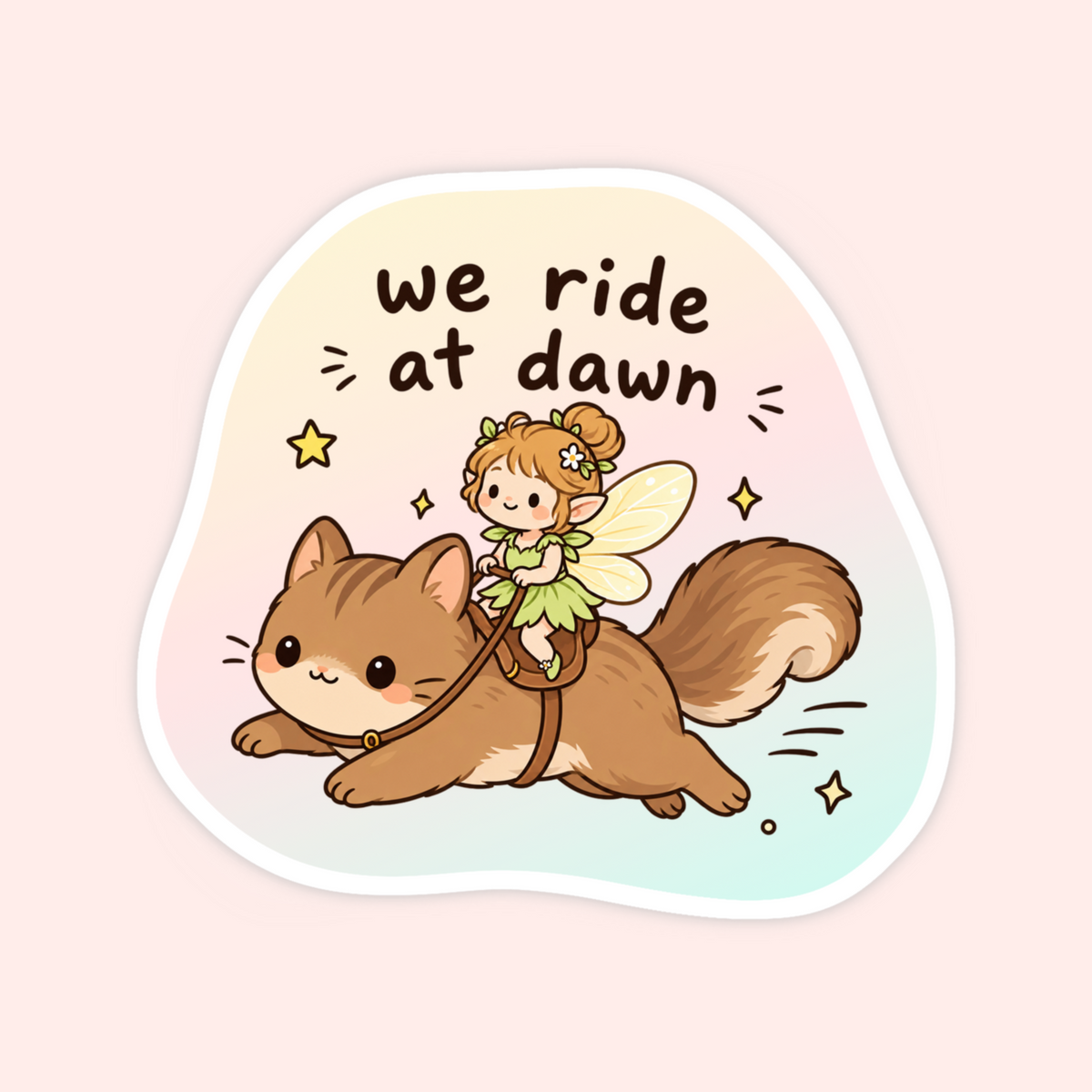 A die-cut sticker featuring a cute cartoon illustration of a brown cat being ridden by a small fairy, with the text 'we ride at dawn' above them. The sticker has a white border and is shown on a soft pastel pink background.