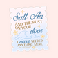 A die-cut decorative sign or sticker with a scalloped edge, featuring the phrase “Salt Air and the rust on your door I never needed anything more” in blue and gold lettering with star and wave illustrations, shown on a pale pink background.