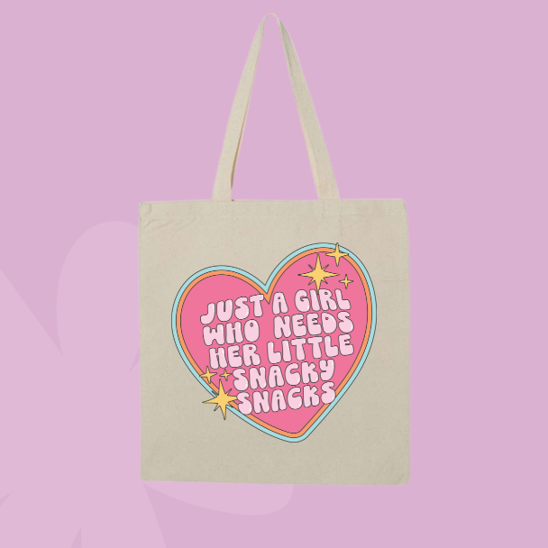 Funny snack themed tote bag with pink heart graphic and text reading just a girl who needs her little snacky snacks.