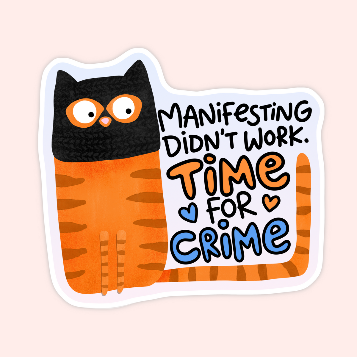 A die-cut sticker featuring a cartoon cat with a black head and orange striped body, next to the text 'MANIFESTING DIDN'T WORK. TIME FOR CRIME' in black, orange, and blue lettering, shown on a pale pink background.
