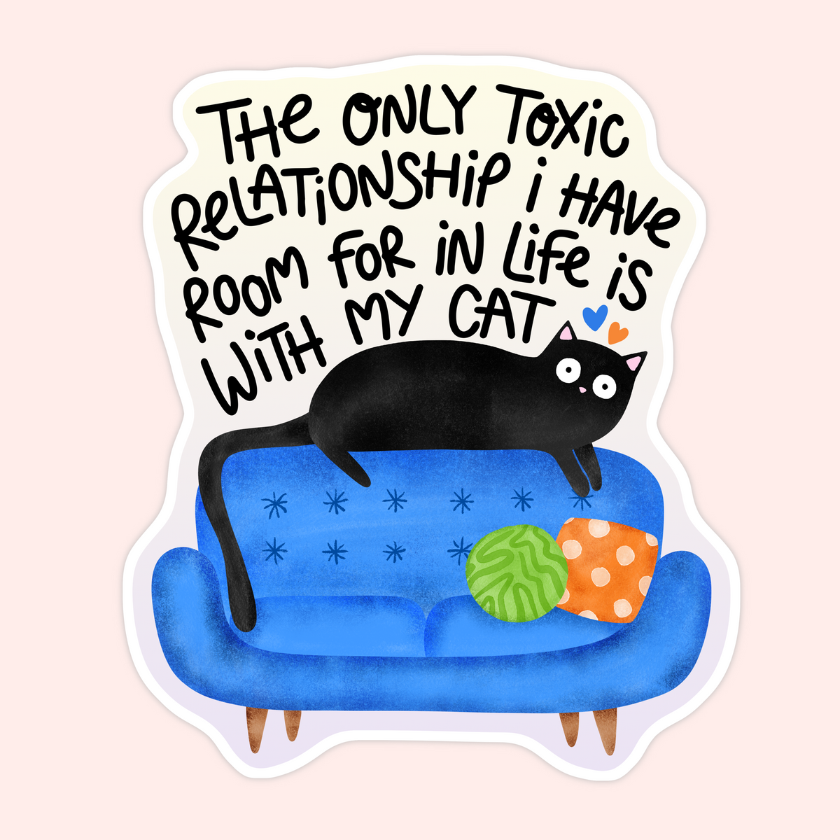 A die-cut sticker featuring a black cat lounging on a blue sofa with two colorful pillows, beneath the hand-lettered quote: 'THE ONLY TOXIC RELATIONSHIP I HAVE ROOM FOR IN LIFE IS WITH MY CAT.' The sticker is shown on a pale pink background.