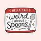 A die-cut sticker with a retro television outline and the text 'HELLO I AM weird about spoons' in black script and block lettering, with a gray spoon illustration and small pink and gold accents, shown on a pale pink background.